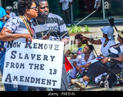 An African-American man and woman take their photograph using a “selfie stick” outside the South Carolina State House, July 10, 2015, in Columbia, S.C Stock Photo