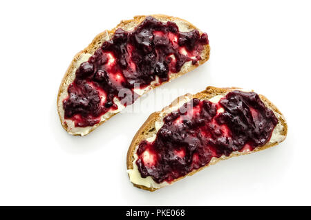 Top view of two pieces of bread with jam and butter isolated on a white background. Stock Photo