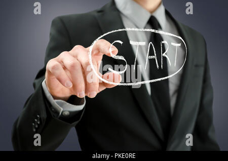Business man pressing start button on a virtual board. Stock Photo