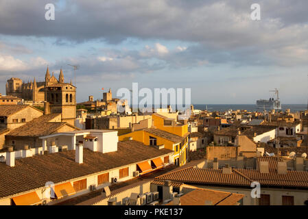 Palma, Majorca. City rooftops and cathedral in evening light with cruise liner leaving port. Stock Photo