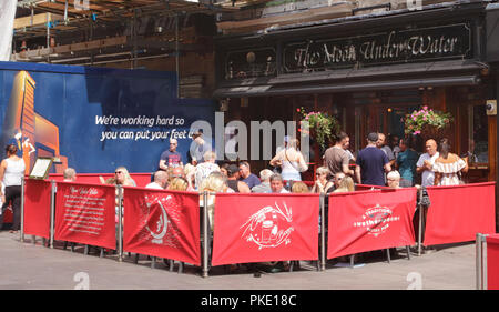 London pub; People drinking at the Moon Under Water, a Wetherspoons Pub ...