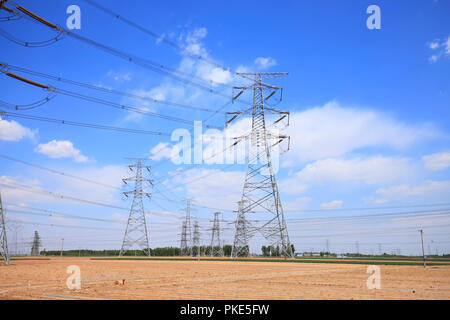 High voltage towers, under the blue sky white clouds Stock Photo - Alamy