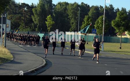 U.S. Army Brig. Gen. Chris LaNeve (front right), commanding general of the 7th Army Training Command, leads a formation of several thousand Soldiers during a team-building run in Grafenwoehr, Germany, July 25, 2018.  The run included Soldiers from U.S. Army Europe’s 3 permanently assigned combat brigades - the 173rd Airborne, 12th Combat Aviation Brigade and the 2nd Cavalry Regiment — as well as Soldiers from U.S. Army Garrison Bavaria and 7th ATC.  This is the first combined event since 7th ATC assumed readiness responsibilities over the 3 combat brigades this summer. Stock Photo