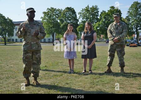 U.S. Army Command Sgt. Maj. Gregory D. Rowland, left, 2d Theater Signal Brigade senior enlisted leader, delivers a speech shortly before the 44th Expeditionary Signal Battalion’s change of responsibility ceremony from Command Sgt. Maj. Chad S. Yeager, right, to Command Sgt. Maj. Sean P. Mitcham (not pictured) at Tower Barracks, Grafenwoehr, Germany, July 27, 2018. Stock Photo