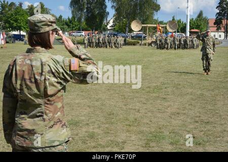 The 44th Expeditionary Signal Battalion Commander U.S. Army Lt. Col. Heather McAteer, left, and the battalion’s new Command Sgt. Maj. Sean P. Mitcham, right, salute to conclude the change of responsibility ceremony at Tower Barracks, Grafenwoehr, Germany, July 27, 2018. Stock Photo