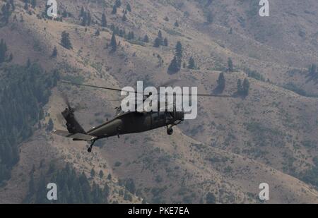 A UH-60 Black Hawk assigned to the Idaho Army National Guard’s 183rd Aviation Battalion flies over the foothills in Boise, Idaho, July 26, 2018. The Black Hawk was used to transport members of the Idaho Wing Civil Air Patrol during a flight tour of the Treasure Valley. Stock Photo