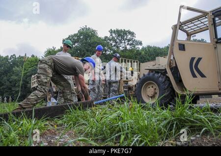 Engineers from the Army Reserve 377th Engineer Company, cut steel wire while restoring a 25-meter range at the Keystone Local Training Area, located in Conneaut Lake, Pennsylvania, July 25. The Keystone Local Training Area spans over 60 acers of land with various training areas for local reservists, National Guard Soldiers and some local police department officials. Stock Photo