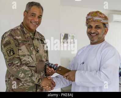 U.S. Army Lt. Gen. Michael X. Garrett, U.S. Army Central commander, presents Brig. Gen. Salim Al-Salimi, senior liaison officer for the Secretary General of Minister of Defence Oman, with a token of appreciation, July 25, 2018. Lt. Gen. Garrett visited with Omani partners to strengthen collaboration and to support enduring USARCENT cooperation in the region. Stock Photo