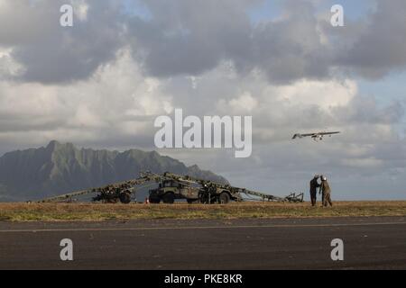 MARINE CORPS BASE HAWAII (July 29, 2018) U.S. Marines with Marine Unmanned Aerial Vehicle Squadron 3, launch an RQ-7B Shadow Unmanned Aircraft System (UAS)in support of the amphibious landing demonstration as part of Rim of the Pacific (RIMPAC) exercise Marine Corps Base Hawaii July 29, 2018. The launch was the last flight for the Shadow in the U.S. Marine Corps in which the platform will be replaced with the RQ-21 Blackjack, a technologically superior and expeditionary UAS.  RIMPAC provides high-value training for task-organized, highly capable Marine Air-Ground Task Force and enhances the cr Stock Photo