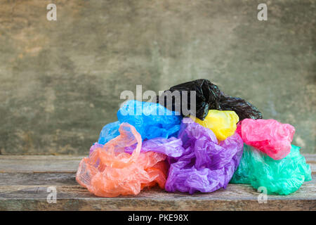 Different plastic bags on wooden background. Stock Photo