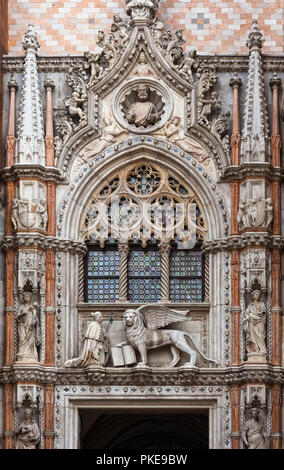 Statue of Doge and winged lion, symbol of Saint Mark, above doorway entrance to Doge's Palace, St. Mark's Square; Venice, Italy Stock Photo