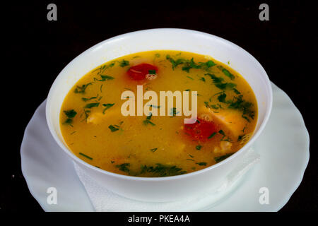 Fish soup with salmon and tomato - Uha Stock Photo