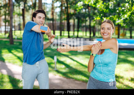Delighted joyful people enjoying doing sports activities Stock Photo