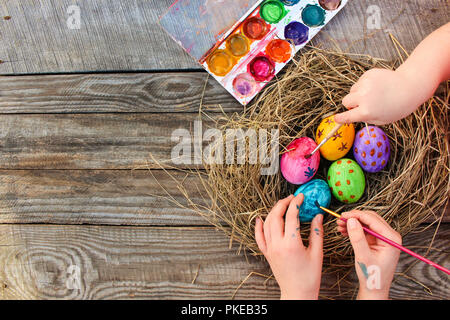 Children paints Easter eggs. Stock Photo