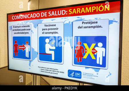 Miami Florida,International Airport MIA,health information sign,CDC,Center for Disease Control,sarampion,measles warning,vaccine,Spanish language,FL18 Stock Photo