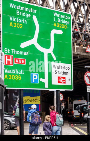 London England,UK,South Bank,Lambeth,road traffic sign,directional directions,Westminster Bridge,Waterloo train rail station,pedestrian,woman female w Stock Photo