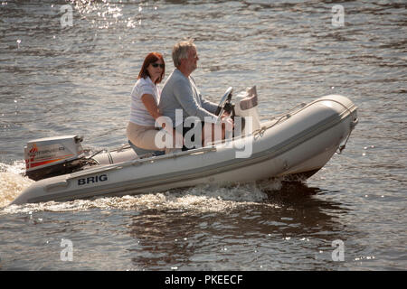 Couple sailing pass in a Brig Falcon rigid inflatable RIB speedboat Stock Photo