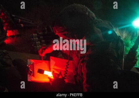 Fire Direction Center and Tank Commander Sgt. Steven Rinck of Headquarters and Headquarters Company, 2nd Battalion, 69th Armor Regiment, 2nd Armored Brigade Combat Team, communicates with Fire Support Teams by using a Joint Battle Command-Platform radio during night operations of Gunnery Tables IV, V, and VI at Fort Stewart, Ga., July 24. The mortar platoons mission is to provide close and immediate indirect fire support for battalions and companies. Stock Photo