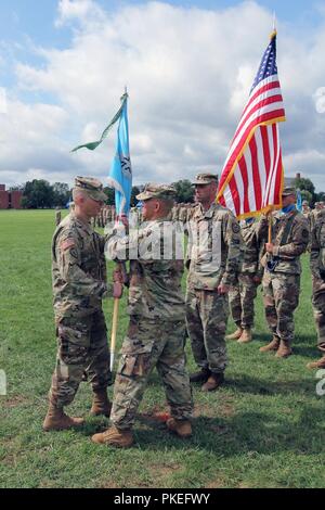 FORT GEORGE G. MEADE, Md. – Lt. Col. Justin Considine (right), the outgoing commander of the 781st Military Intelligence (MI) Battalion (Cyber), passes the battalion colors to Col. Brian Vile, commander of the 780th MI Brigade (Cyber), during a change of command ceremony on the McGlachlin Parade Field Aug. 1. Stock Photo