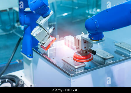 Industrial robot working in phone factory Stock Photo