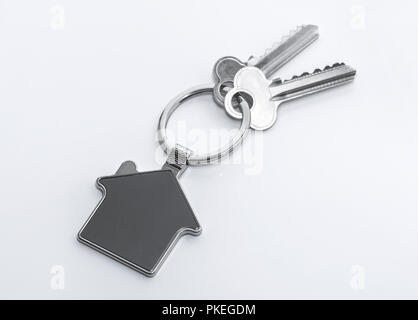 Key and keychain in the shape of a house isolated on white background. Stock Photo