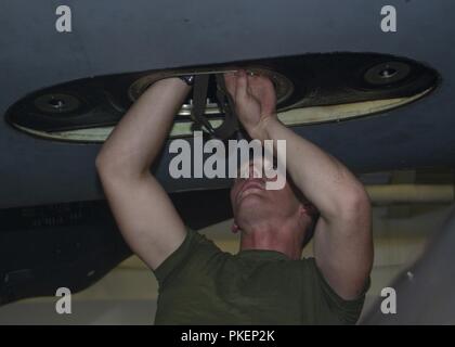 PACIFIC OCEAN (July 30, 2018) – Marine Corps Lance Cpl. Jake Hoschar, assigned to the “Sea Elks” of Marine Medium Tiltrotor Squadron (VMM) 166 (REIN), performs maintenance on a fuel cell of an MV-22 Osprey tiltrotor aircraft in the hangar bay of Wasp-class amphibious assault ship USS Essex (LHD 2) during a regularly scheduled deployment of Essex Amphibious Ready Group (ARG) and 13th Expeditionary Unit (MEU). The Essex ARG/13th MEU is a capable and lethal Navy-Marine Corps team deployed to the 7th fleet area of operations to support regional stability, reassure partners and allies and maintain  Stock Photo