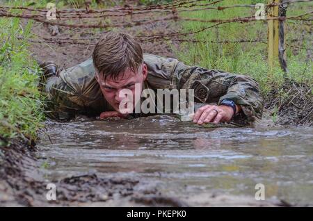 Spc. Aaron Tolson, a paratrooper assigned to the 1st Battalion, 508th Parachute Infantry Regiment, 3rd Brigade Combat Team, 82nd Airborne Division navigates a low-crawl obstacle during the 82nd Airborne Division’s Best Medic Competition held on Fort Bragg from 25 to 26 July.  The competition determined the two medics sent by the division to compete in the Army-wide competition scheduled for September. Stock Photo