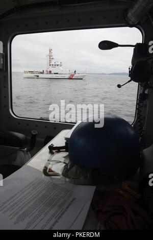 The crew of the Coast Guard Cutter Terrapin, an 87-foot patrol boat homeported in Bellingham, stand by to enforce a security zone during the 69th Annual Seafair Parade of Ships in Elliot Bay, Wash., July 31, 2018.    The view of the cutter was captured from inside a 45-foot Response Boat-Medium from Coast Guard Station Seattle, whose crew also conducted security zone enforcement.    U.S. Coast Guard Stock Photo