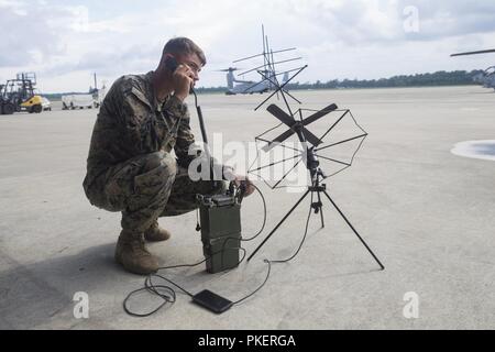 Lance Cpl. William Gabriel,  a radio operator with Battalion Landing Team , 1st Battalion, 2nd Marine Regiment, 22nd Marine Expeditionary Unit, prepares for an airfield seizure during Realistic Urban Training at Marine Corps Air Station New River, N.C., July 26, 2018. This training prepares the MEU Command Element to coordinate operations and logistics in an urban environment. Stock Photo
