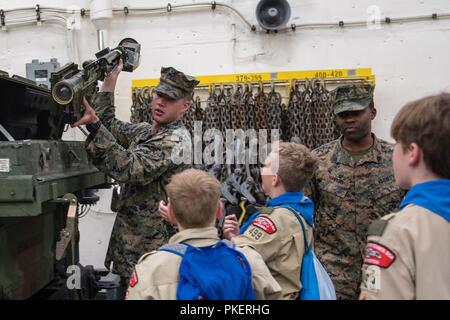 PUGET SOUND, Wash. (July 31, 2018) Private First Class Callen Shouts displays a Shoulder-Launched Multi-Purpose Assault Weapon to ship riders onboard the amphibious transport dock ship USS Somerset (LPD 25). Somerset is arriving in Seattle for Seafair Fleet Week, an annual celebration of the sea services wherein Sailors, Marines and Coast Guard members from visiting U.S. Navy and Coast Guard ships and ships from Canada make the city a port of call. Stock Photo