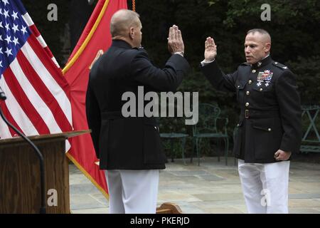 Commandant of the Marine Corps Gen. Robert B. Neller, left, promotes Col. Daniel J. Lecce, right, during a ceremony held at Marine Barracks Washington, D.C., July 30, 2018. Col. Lecce was promoted to Maj. Gen. and appointed as the staff judge advocate to the Commandant of the Marine Corps. Stock Photo