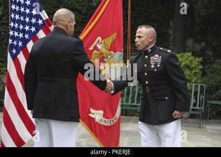 Commandant of the Marine Corps Gen. Robert B. Neller, left, shakes hands with Col. Daniel J. Lecce, right, during a ceremony held at Marine Barracks Washington, D.C., July 30, 2018. Col. Lecce was promoted to Maj. Gen. and appointed as the staff judge advocate to the Commandant of the Marine Corps. Stock Photo