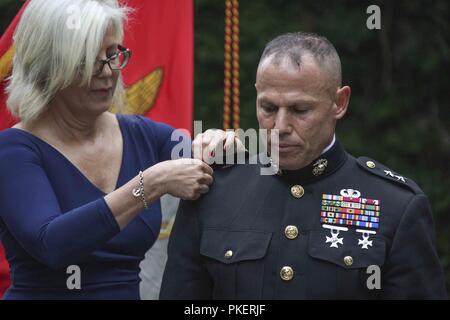 Marine Col. Daniel J. Lecce, right, is pinned by his wife, Jean Kilker, during a ceremony held at Marine Barracks Washington, D.C., July 30, 2018. Col. Lecce was promoted to Maj. Gen. and appointed as the staff judge advocate to the Commandant of the Marine Corps. Stock Photo