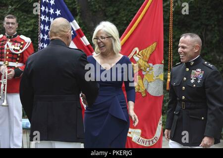 Jean Kilker, wife of Maj. Gen. Daniel J. Lecce, shakes hands with the Commandant of the Marine Corps Gen. Robert B. Neller during a ceremony held at Marine Barracks Washington, D.C., July 30, 2018. Lecce was promoted from Col. to Maj. Gen. and appointed as the staff judge advocate to the Commandant of the Marine Corps. Stock Photo
