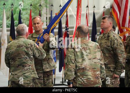 Col. Richard A. Martin, commander, Aviation Center Logistics Command, assumes command from Col. Michael J. Best as he accepts the colors from Maj. Gen. Douglas M. Gabram, commanding general, U.S. Army Aviation and Missile Command, during a change of command ceremony at the U.S. Army Aviation Museum July 31. Stock Photo