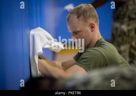 SEATTLE (Aug 1, 2018) U.S Marine Corps 1st Lieutenant Samuel Banks cleans gym equipment at the Young Men's Christian Association during Seafair Fleet Week. Seafair Fleet Week is an annual celebration of the sea services wherein Sailors, Marines and Coast Guard members from visiting U.S. Navy and Coast Guard ships and ships from Canada make the city a port of call. Stock Photo
