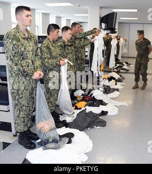 LAKES, Ill. (July 26, 2018) Naval ROTC midshipman candidates prepare for a compartment inspection under the supervision of upperclassmen midshipman instructors in the USS Triton Recruit Barracks at Recruit Training Command (RTC). More than 65 young men and women entering their freshman year of the NROTC program participated in a two-week pilot program designed to provide standardized entry-level militarization and prepare midshipmen with a common training orientation.  The indoctrination serves as a standard training launch point for the future naval and Marine Corps officers, and for the deve Stock Photo