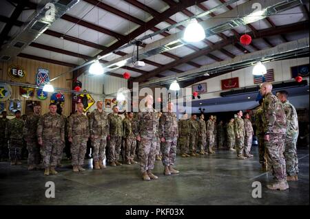 Task Force Alamo stands ready for the beginning of the patching ceremony on Camp Lemonnier, Djibouti, August 2, 2018. August 2nd was the 30-day mark for Task Force Alamo’s deployment, the first opportunity for these Soldiers to wear their deployment patches. Stock Photo