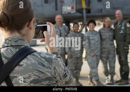 Airman 1st Class Taylor Walker, a photojournalist with the 124th Fighter Wing, takes a picture of the 124th Fighter Wing staff in front of an A-10 Thunderbolt II at Gowen Field, Boise, Idaho Aug. 2, 2018. The staff was bidding farewell to Chief Master Sgt. Tammy Ladley, the 124th Fighter Wing command chief, on one her last days after her 32 years of service. Stock Photo