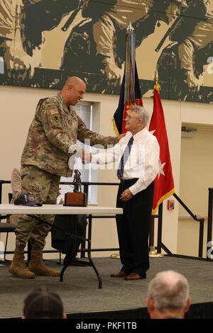 Maj. Gen. Michael Thompson (left), adjutant general for Oklahoma, accepts a statuette of the famed 'Follow Me' statue, also known as 'Iron Mike,' that stands outside of the U.S. Army's infantry school at Fort Benning, Georgia. The award was presented by Col. (ret.) J.L. Rhodes, of the Combat Infantryman's Association, for the sacrifices made by combat infantrymen of the Oklahoma Army National Guard. The presentation ceremony took place at the Brigade's headquarters in Norman, Oklahoma, Aug. 5 Stock Photo