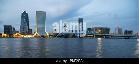 Building lights reflect in the St Johns River as night fall and a storm passes over Jacksonville Florida Stock Photo