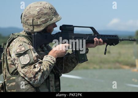 A member of the Montenegrin Armed Forces executes a Combat Marksmanship Program range during Exercise Platinum Lion 18 at Novo Selo Training Area, Bulgaria, Aug. 1, 2018. Platinum Lion is an annual field training exercise that reinforces relationships in a joint training environment, builds understanding of partner nation tactics, techniques and procedures, and increases interoperability with Allied and partner forces. Stock Photo