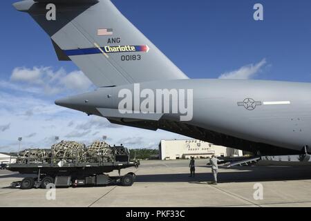 Three pallets of Army luggage is loaded aboard a North Carolina Air National Guard (NCANG) C-17 Globemaster III Aircraft as part of the very first C-17 mission for the NCANG to Pope Army Airfield, while at Pope Army Airfield, Fayetteville North Carolina, August 1, 2018. The mission to Pope Field is the first of what is hoped to be many, by October the 145th Airlift Wing plans to begin supporting Airdrop missions with weekly flights to Pope Field, picking up Soldiers and Cargo for regular Airborne operations. Stock Photo