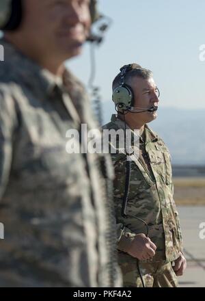 Brig. Gen. Michael J. Garshak, the adjutant general of Idaho and commander of the Idaho National Guard, listens and watches a pilot prepare to take off in an A-10 Thunderbolt II assigned to the 190th Fighter Squadron at Gowen Field, Boise, Idaho Aug. 5, 2018. Garshak worked with Staff Sgt. Jeremy Johnson, a 124th Aircraft Maintenance Squadron crew chief, to learn more about what it takes to launch an aircraft. Stock Photo