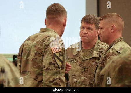 Maj. Gen. Mark O'Neil (center), commander of U.S. Army Alaska, converses with I Corps commanding general, Lt. Gen. Gary Volesky (left), at the Stryker Warfighter Forum Leader's Summit August 1, 2018 on Joint Base Lewis-McChord. The two-day summit brings together senior leaders, Department of the Army civilians and industry experts to discuss the modernization of the Stryker and how it fits into the Army's readiness to deploy, fight and win on tomorrow's battlefield. Stock Photo