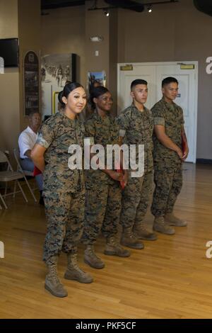 U.S. service members and civilians attend an award ceremony at Marine Corps Recruit Depot San Diego, Calif., Aug. 8, 2018. The ceremony was held in honor of the Marines and Sailors that were awarded the service member of the quarter award for their achivements throught 3rd quarter of fiscal year 18 Stock Photo
