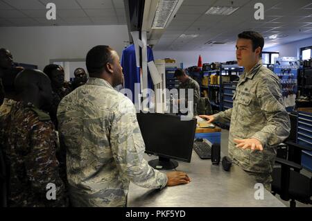 U.S Air Force Senior Airman Robert Campos, Consolidated Tool Kit Maintainer, assigned to 86th Air Maintenance Squadron Support Section, describes aircraft tool management to participants of African Partnership Flight, hosted by U.S. Air Forces Africa and co-hosted by Mauritania and Senegal at Ramstein Air Base, Germany, Aug. 7, 2018. The APF program is Air Forces in Africa's premier security cooperation program with African partner nations to improve professional military aviation knowledge and skills. Stock Photo