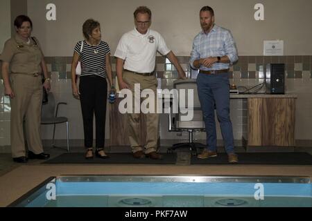 The Honorable Mr. Thomas B. Modly, center, undersecretary of the Navy, Department of the Navy, and his wife Robyn Modly, left, are given a tour of Wounded Warrior Battalion-West (WWBn-W), at WWBn-W, Marine Corps Base Camp Pendleton, California, Aug. 8, 2018.  Modly was given a tour around Marine Corps Base Camp Pendleton to see various aspects of the base and its residents. Stock Photo