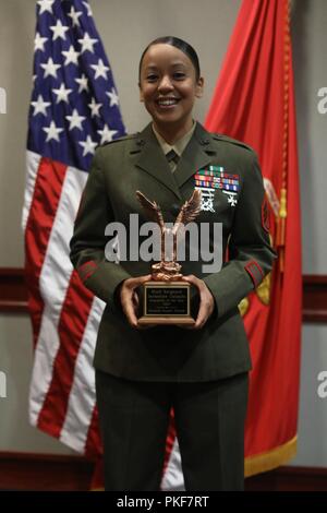 U.S. Marine Corps Staff Sergeant Jackeline Calzada, an instructor assigned to Ground Supply School (GSS), Marine Corps Combat Service Support Schools poses for a photo during the Instructor of the Year Ceremony at Camp Johnson, N.C., August 6, 2018. The Instructor of the Year Ceremony recognizes instructors who have demonstrated sustained superior performance in their instructional abilities. Stock Photo