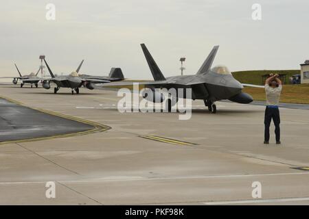 U.S. Air Force F-22 Raptors from the 95th Fighter Squadron, 325th Fighter Wing at Tyndall Air Base, Fla., arrive at Spangdahlem Air Base, Germany, Aug. 8, 2018. The 95th FS is deployed to Europe for several weeks to conduct training with other European-based aircraft as part of a Flying Training Deployment. Forward locations enable collective defense capabilities and provide U.S. and NATO the strategic and operational breadth needed to deter adversaries and assure our allies and partners. Stock Photo